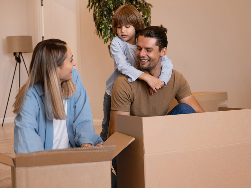 Happy family moving house with child